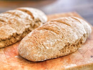 Fresh bread loafs on table in bakery