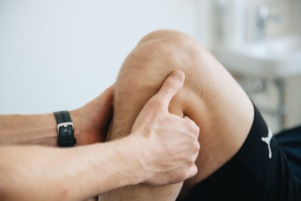 A man is getting his knee checked by a doctor